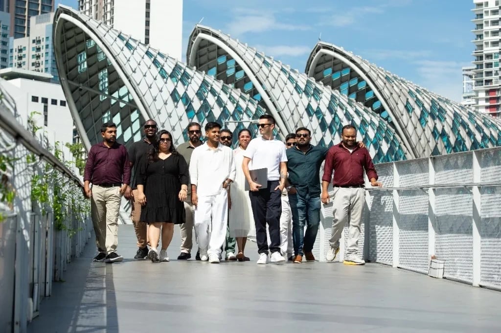 The Mr Digital team walking together across a footbridge